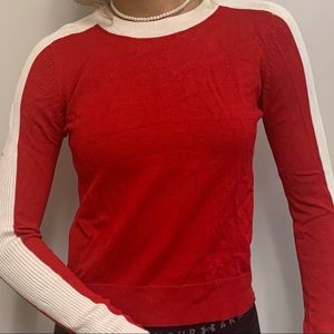 red crop top with white lines on the sleeve